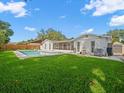 Spacious backyard features a pristine pool and well-maintained lawn at 4016 Windtree Dr, Tampa, FL 33624