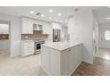 Modern kitchen with white cabinets, stainless steel appliances, and island at 4016 Windtree Dr, Tampa, FL 33624