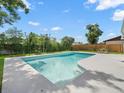 A backyard swimming pool offers a refreshing outdoor retreat at 4016 Windtree Dr, Tampa, FL 33624