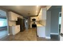 Bright kitchen features white cabinets, stainless steel appliances, and tile flooring at 4374 32Nd N Ter, St Petersburg, FL 33713