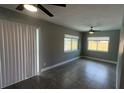 Open-concept living room featuring tile flooring, ceiling fan, and sliding glass doors to the backyard at 4374 32Nd N Ter, St Petersburg, FL 33713
