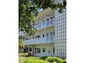 View of the apartment featuring balconies, white railings, and a decorative white privacy screen at 5155 9Th N Ave # 311, St Petersburg, FL 33710