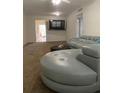 A well-lit living room with an expansive sectional sofa and a view into the hallway at 5155 9Th N Ave # 311, St Petersburg, FL 33710