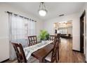 Cozy dining room featuring hardwood floors and ample natural light at 5533 Golden Nugget Dr, Holiday, FL 34690