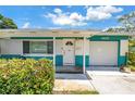 View of the front entrance with a white door and an attached one car garage at 6195 28Th N Ave, St Petersburg, FL 33710
