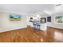 An open-concept living room with hardwood floors and a view of the kitchen at 6195 28Th N Ave, St Petersburg, FL 33710
