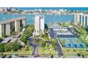 A beautiful waterfront condo complex featuring mature landscaping, covered parking, and tennis courts at 660 Island Way #206 # 206, Clearwater, FL 33767