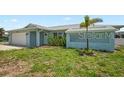 Inviting single-story home featuring a tidy lawn and an attached two-car garage at 7322 Ellis Ln, Port Charlotte, FL 33981