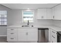 Bright kitchen with stainless steel appliances, white cabinets, and modern countertops at 7322 Ellis Ln, Port Charlotte, FL 33981