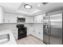 Modern kitchen with stainless steel appliances, white cabinets, and stylish countertops at 7322 Ellis Ln, Port Charlotte, FL 33981