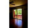 View of the balcony from the living room with a sliding glass door and hardwood floors at 8220 12Th N Way # H, St Petersburg, FL 33702