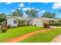 Lovely home with well-kept lawn, mature landscaping, and an attached garage at 859 Harbor Hill Dr, Safety Harbor, FL 34695