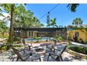 Relaxing backyard featuring a cozy fire pit area, sparkling pool, and lush greenery for a private outdoor retreat at 859 Patterson Dr, Sarasota, FL 34234