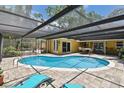 Enjoy this private backyard oasis with a sparkling pool, shaded pergola, and brick paver patio for ultimate relaxation at 859 Patterson Dr, Sarasota, FL 34234