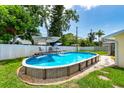 Backyard featuring an above-ground pool with deck and lounge area, ideal for outdoor relaxation at 11398 88Th Ave, Seminole, FL 33772