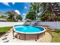 Backyard featuring an above-ground pool with deck and lounge area, perfect for summer fun at 11398 88Th Ave, Seminole, FL 33772