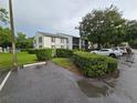 Condo building with a well-manicured lawn and parking lot, offering convenience and curb appeal at 1281 Pine Ridge E Cir # B1, Tarpon Springs, FL 34688