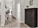 Inviting hallway with stylish wood-look flooring and contemporary decor at 13111 Fruitville Way, Riverview, FL 33579