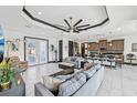 Expansive living space with a view of the kitchen, featuring tiled flooring, modern decor, and an open layout at 200 Eppinger Dr, Port Charlotte, FL 33953