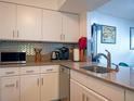 Kitchen with granite counters, stainless steel appliances, tile backsplash and lots of storage at 2333 Feather Sound Dr # B609, Clearwater, FL 33762