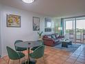 Open concept living space with tile floors, dining area, balcony and comfortable seating at 2333 Feather Sound Dr # B609, Clearwater, FL 33762
