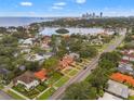 Stunning aerial view showcasing a waterfront community with beautiful homes, lush greenery, and city skyline backdrop at 243 Snell Isle Ne Blvd, St Petersburg, FL 33704