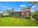 Lush backyard featuring a screened-in porch and beautiful green lawn at 243 Snell Isle Ne Blvd, St Petersburg, FL 33704