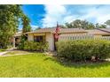 Charming single-story home featuring a well-manicured lawn, mature landscaping, and a quaint picket fence at 2922 60Th W St, Bradenton, FL 34209