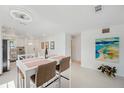 Open dining area with modern table and view of the updated kitchen at 3114 59Th S St # 101, Gulfport, FL 33707