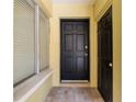 Welcoming entrance to unit 120 with black door and tiled entryway at 3206 W Azeele St # 120, Tampa, FL 33609
