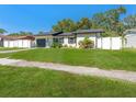 Charming single-story home with lush green lawn and white picket fence bordering the property lines at 4111 Whiting Se Dr, St Petersburg, FL 33705