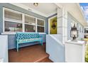 Inviting covered porch with a colorful bench and decorative details at 4211 28Th N Ave, St Petersburg, FL 33713