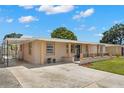 View of home exterior showing side driveway and access to the front entrance at 4414 W Hanna Ave, Tampa, FL 33614