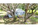 Inviting single-story home with a new wooden deck nestled under mature trees at 44912 Lacoochee Claysink Rd, Webster, FL 33597