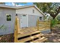 Close up of the home's entrance featuring a new wooden porch and decorative door at 44912 Lacoochee Claysink Rd, Webster, FL 33597