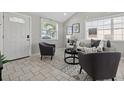 Cozy living area showcasing tile floors, modern furnishings, and natural light streaming through the windows near the entry at 4870 47Th N Ave, St Petersburg, FL 33714