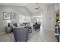 Bright living room with neutral paint, tile floors, vaulted ceiling, stylish decor, and access to the dining area at 4870 47Th N Ave, St Petersburg, FL 33714
