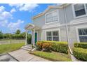 Attractive townhome showcasing a vibrant green door and well-maintained front yard at 5501 67Th N Ave # 11, Pinellas Park, FL 33781