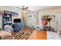 A cozy living room with hardwood floors and a large window at 5501 67Th N Ave # 11, Pinellas Park, FL 33781