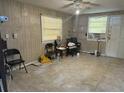 Cozy living room with tile floors, natural light from two windows, and neutral wall colors at 5807 N Hale Ave, Tampa, FL 33614