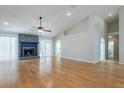 Spacious living room with vaulted ceilings, hardwood floors and a stone fireplace at 6123 India Dr, Spring Hill, FL 34608