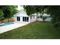 An inviting backyard with a sparkling pool, spacious patio, and freshly manicured lawn at 6332 Emerson S Ave, St Petersburg, FL 33707