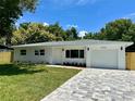 Charming single-story home boasting a well-manicured lawn and a paved driveway, blending comfort and curb appeal at 6332 Emerson S Ave, St Petersburg, FL 33707