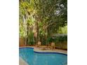 Relaxing poolside patio with seating and tropical landscaping creates a tranquil outdoor oasis at 6332 Emerson S Ave, St Petersburg, FL 33707