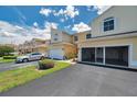Lovely exterior view of a townhouse with an attached garage and well-manicured lawn at 6400 46Th N Ave # 61, Kenneth City, FL 33709