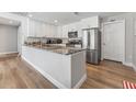 Updated kitchen with white cabinets, stainless steel refrigerator and large island with countertop at 7210 14Th N St, St Petersburg, FL 33702