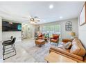 Cozy living room featuring modern furnishings, tile floors, a ceiling fan, and plenty of natural light at 7211 Red Oak Loop, New Port Richey, FL 34654
