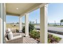 Enjoy stunning lake views from this home's relaxing covered patio with comfortable seating and lush landscaping at 7621 Highgrove Ave, Bradenton, FL 34210