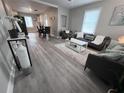 Open-concept living room with hardwood floors and a cozy seating area, ideal for entertaining guests at 921 Grand Central St, Clearwater, FL 33756