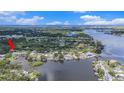 Waterfront home surrounded by lush greenery, showcasing private dock and tranquil waterfront living at 9938 Alavista Dr, Gibsonton, FL 33534